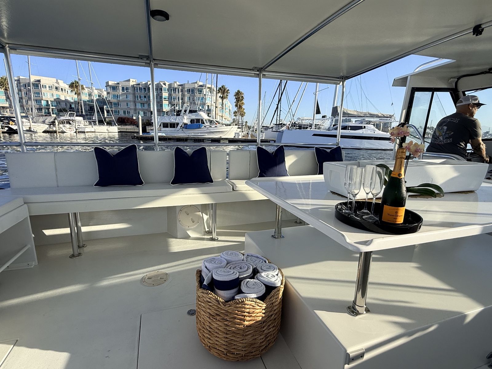 Captain at the helm of Aurora Sol during a private harbor charter in Marina del Rey