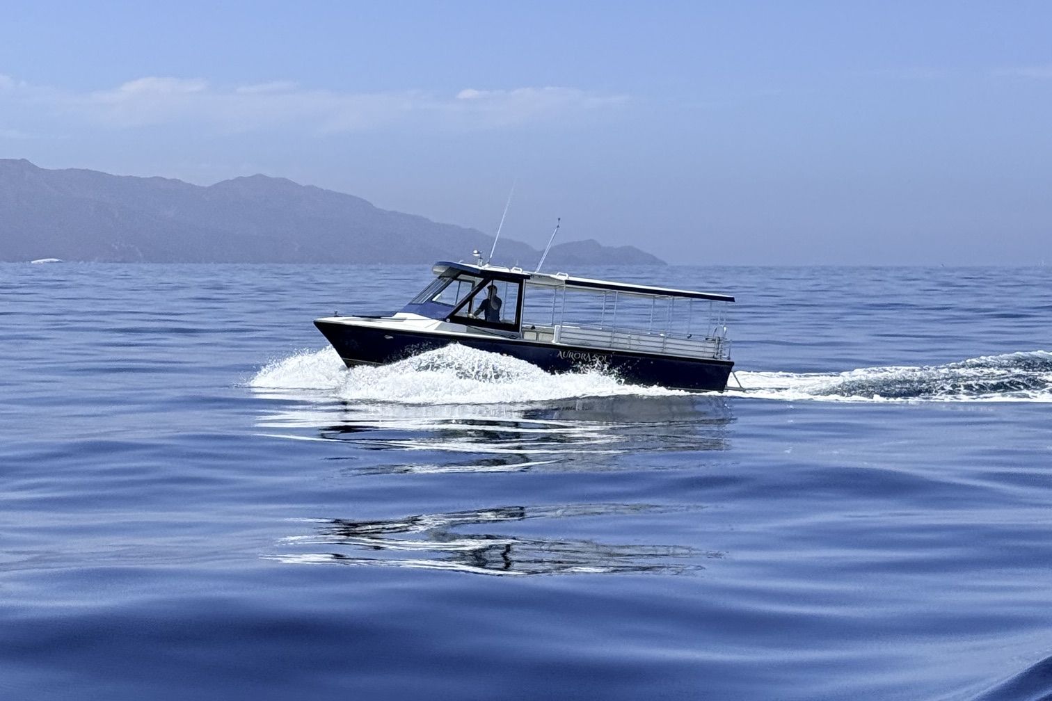 Aurora Sol cruising deep blue water beyond the Marina del Rey breakwater