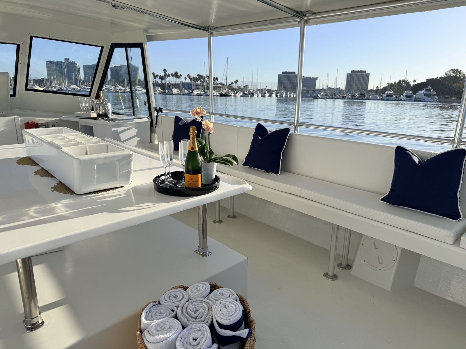 Main deck lounge seating and table aboard the Aurora Sol harbor cruise boat