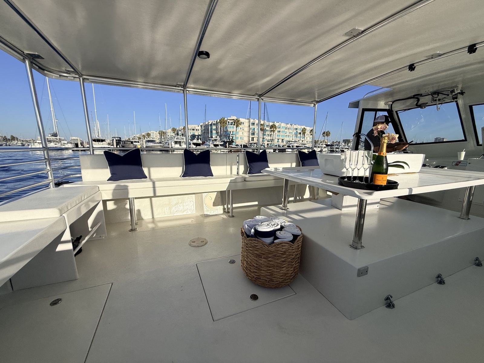 Open deck seating aboard Aurora Sol with the Marina del Rey waterfront behind